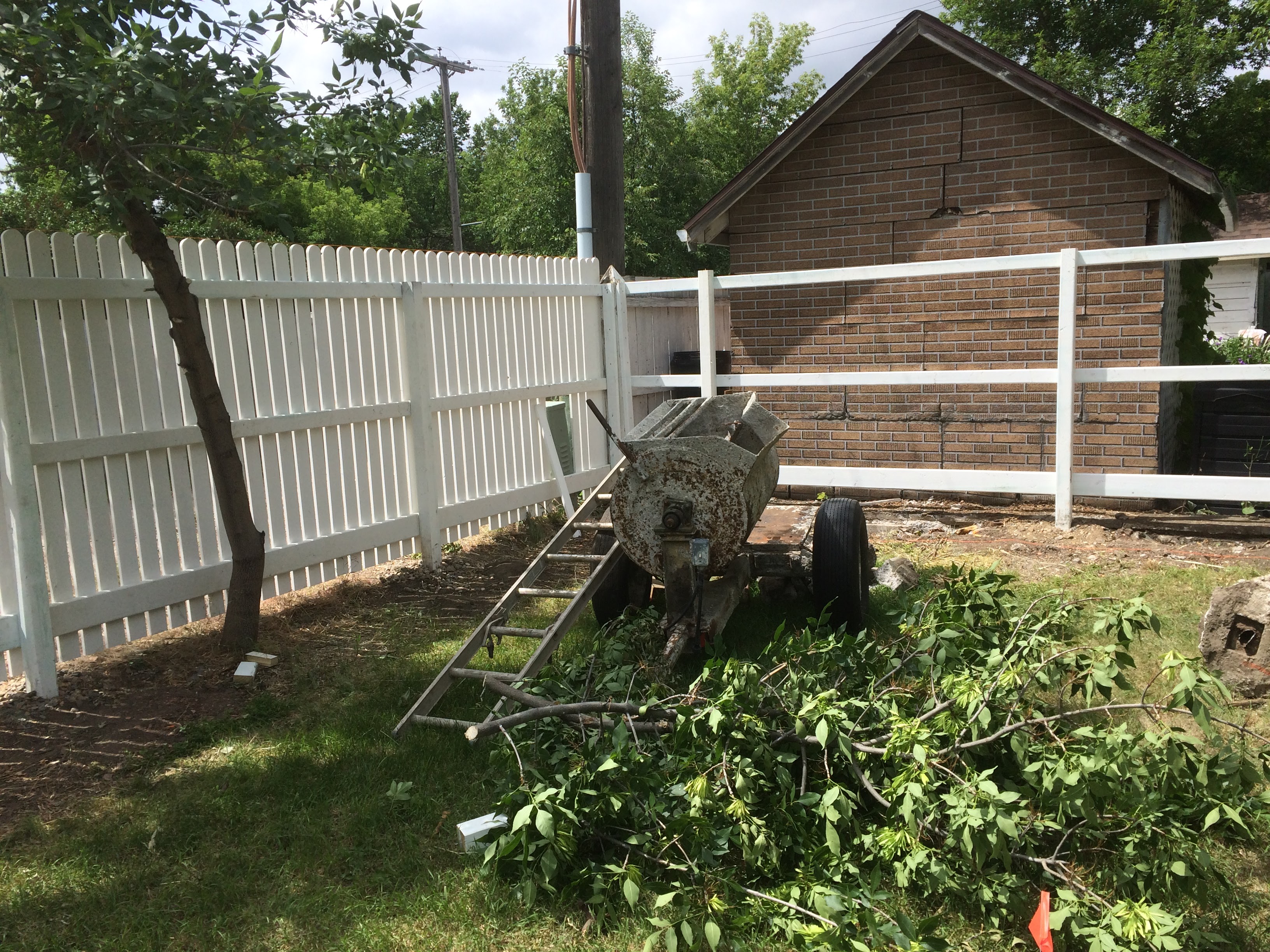 White Picket Fence by Brick Garage